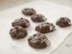 chocolate covered cookies sitting on top of a piece of paper