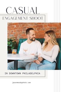 a man and woman sitting at a table in front of a brick wall with the title casual engagement shoot