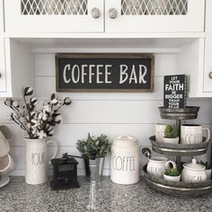 a coffee bar with cups and mugs on the counter in front of a sign that says coffee bar