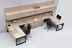 an office cubicle with two desks and chairs