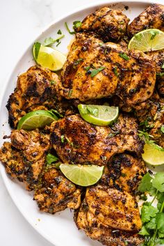 chicken marinade with cilantro and limes on a white plate next to the recipe title