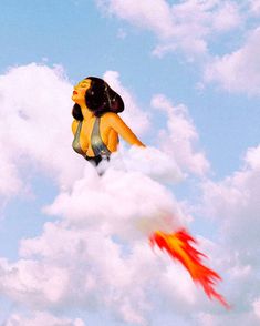 a woman flying through the air on top of a cloud