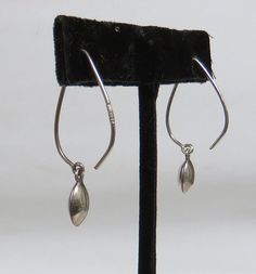 Modernist earrings simple sterling silver wires with drop beads Minimalist earrings are made from a large simple silver wire and a drop that is about the same size and shape as a coffee bean Lovely dangle drops are on sterling silver ear wires, so chic and easy to wear. These are unmarked earrings that were tested with Jeweler's acid the earrings are light weight minimalist earrings the beads are solid Items are second hand, used, may have marks, scratches, bumps etc. I try to describe clearly, Mid Century Earrings, Silver Bead Earrings, Modernist Earrings, Earrings Simple, Drop Beads, Silver Bead, Coffee Bean, Simple Earrings, Bead Earrings