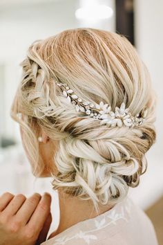 a woman with blonde hair wearing a wedding hairstyle