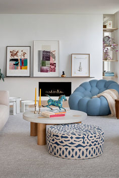 a living room filled with furniture and a fire place in the middle of the room