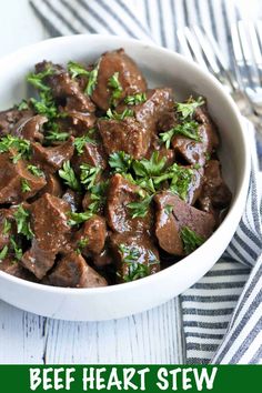 a white bowl filled with beef and parsley