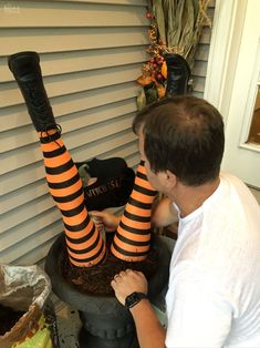 a man in striped socks is decorating a halloween cake