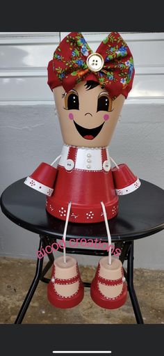 a red and white doll sitting on top of a table