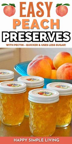 four jars filled with peach preserves sitting on top of a table next to some peaches