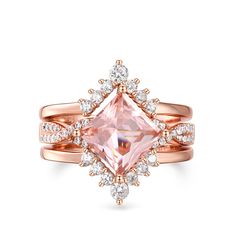 an engagement ring with a pink diamond surrounded by white and rose gold diamonds on the band