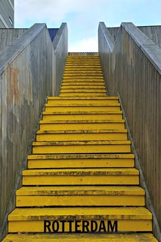 yellow steps leading up to the top of a building with words written in black on them