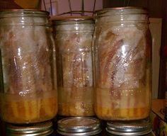 three jars filled with food sitting on top of a stove