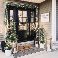 the front door is decorated with christmas trees and wreaths