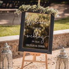 a welcome sign and two lanterns on the ground