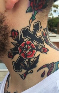 a man with a cross and roses tattoo on his neck