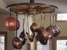 pots and pans hanging from the ceiling in a kitchen