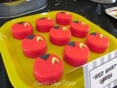 a yellow tray topped with lots of red cakes