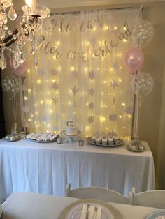 the table is set up with desserts and balloons