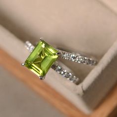 This ring features a 7*9mm natural peridot and sterling silver finished with rhodium. Customization is available. It is made by hand, and it will take about 7 days to finish the ring after your payment is completed. Any question, just let me know. :) My shop homepage: https://www.etsy.com/shop/LuoJewelry?ref=l2-shopheader-name Emerald Cut Peridot Gemstone Jewelry, Lime Green Peridot Ring For May Birthstone, Lime Green Peridot Birthstone Ring For May, Emerald Cut Peridot Ring For May Birthstone, Green Peridot Diamond Ring With Accent Stones, Lime Green Peridot Birthstone Ring For Promise, Lime Green Diamond Ring With Gemstone, Lime Green Peridot Birthstone Ring, Lime Green Diamond Gemstone Rings