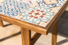 a wooden table with colorful tiles on it