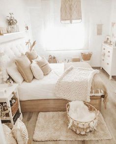 a bedroom with white furniture and lots of pillows on top of the bedspread