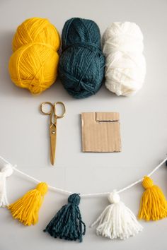 several balls of yarn and scissors on a string