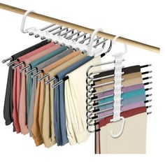 an over the door hanger with several different colored shirts hanging from it's hooks