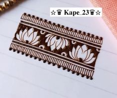 a piece of paper that has some type of decorative design on it, with the words kape 23 in front of it