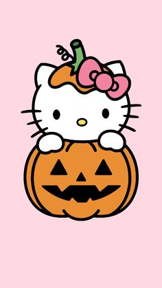 a hello kitty pumpkin sitting on top of a pink background with the word hello kitty written in