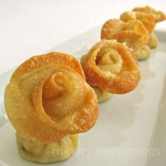 small pastries are lined up on a white plate