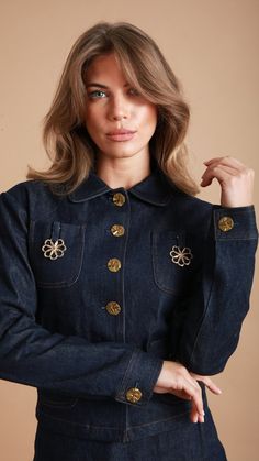 Our Daisy denim jacket has a relaxed classic silhouette with a cropped hem.  This super cute denim jacket is your go to for stylish denim separates with two pockets to front with fixed daisy brooch, stitching and gold feature buttons. The best thing about this denim jacket is the unique design and dropped shoulder. This jacket is made from a  dark denim and is fully lined. Ideal for pairing effortlessly with your existing wardrobe or choose the coordinating daisy jeans or skirt. gentle wash/dry Cropped Denim Top For Work, Cropped Denim Top For Spring Workwear, Chic Medium Wash Denim Jacket With Buttons, Chic Spring Denim Jacket With Buttons, Daisy Jeans, Cute Denim Jacket, Blazer Jackets For Women, Leather Apron, Skirt Fabric