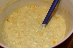 the batter is being mixed with corn in a bowl