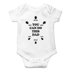 a white baby bodysuit with black arrows on the chest and words that read, you can do this dad