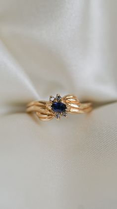 * Ring Material: Blue Sapphire, Diamond, 14K Yellow Gold * Ring Dimensions: 6.7x6.8MM Top Design, 2.3MM Tapering Band * Size: 6.25 * Stone Weight & sizes: Blue Sapphire - 0.13ct, Diamond -0.04ct * Overall weight: 3.7g Midnight Blue Sapphire Ring, 14k Gold Birthstone Cluster Ring, Heirloom Sapphire Cluster Ring For Promise, Heirloom Sapphire Cluster Promise Ring, Gold And Sapphire Ring, Sapphire Cluster Ring For Promise, Heirloom Sapphire Ring With Diamond, Blue Diamond Ring With 14k Gold Accents, 14k Gold Cluster Ring With Birthstone