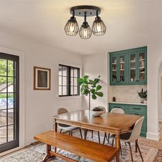 a dining room table and bench in front of an open door