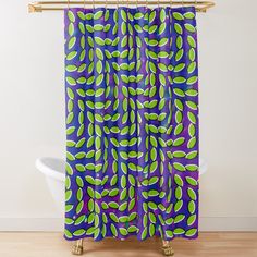 a colorful shower curtain with green and purple leaves on the bottom, in front of a white bath tub