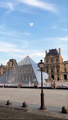 people are walking around in front of the pyramid