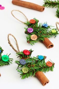 an image of christmas decorations made out of cinnamon sticks and buttons on a white table