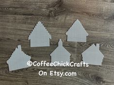 some cut out houses are sitting on a wooden surface with the words coffee shack crafts on it