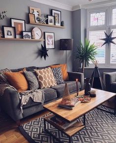 a living room filled with furniture and pictures on the wall above it's coffee table