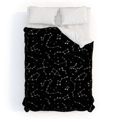 black and white bedding with stars in the night sky on it's side