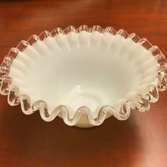 a white bowl sitting on top of a wooden table