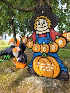 a sign that says welcome to randy's pumpkin patch with mickey mouse in the foreground