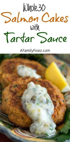 two crab cakes on a plate with lemon wedges