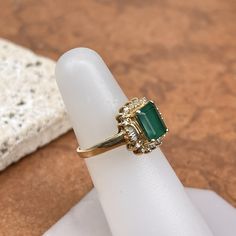 Estate/ vintage 14KT yellow gold lab-created, emerald-cut emerald with surrounding, baguette + round diamonds halo ring. Would make a fantastic emerald engagement ring or just an added ring to your collection! Size 6.25 Can be resized for an additional fee Lab Emerald 1.85~2.00+CTW Emerald-cut emerald measures: 8mm x 5mm Round (14) round natural diamonds; SI clarity; H color, (6) natural, baguette diamonds; VSI clarity; H color Stamped 14K Weight: 3.40 grams Excellent estate condition Baguette Cut Emerald Ring For May Birthstone, Emerald Cut Emerald Ring With Baguette Diamonds, Emerald Cut Baguette Diamonds May Birthstone Jewelry, Emerald Cut Baguette Diamond Jewelry For May Birthstone, May Birthstone Baguette Cut Diamond Rings, Classic Emerald Ring With Baguette Diamonds, Gold Emerald Ring With Baguette Cut Diamond Accents, Rectangular Emerald Ring With Baguette Diamonds For Formal Events, Rectangular Emerald Ring With Baguette Diamonds For Formal Occasions