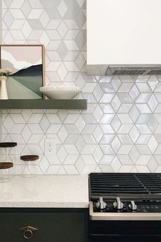 a stove top oven sitting inside of a kitchen next to a wall mounted range hood