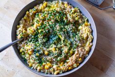 a bowl filled with food on top of a wooden table