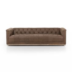 a brown leather couch with buttons on the back and arms, in front of a white background