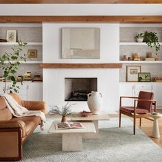 a living room filled with furniture and a fire place in the middle of a room