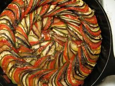 a pan filled with sliced up vegetables on top of a stove